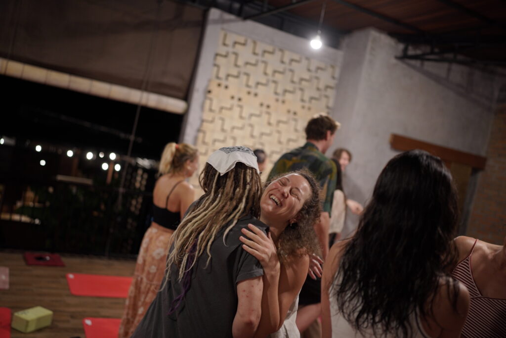 Guests sharing Laughing Meditation in open‑air pavilion at Dedeane Ubud